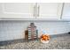 Kitchen detail showcasing white cabinets, granite countertops, and subway tile backsplash at 1099 Valentine Ln, Carmel, IN 46032