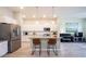 Modern kitchen featuring a center island with seating, stainless steel appliances, and ample counter space at 1099 Valentine Ln, Carmel, IN 46032
