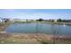Scenic view of a tranquil pond in a neighborhood, featuring a fountain and surrounding residences at 1099 Valentine Ln, Carmel, IN 46032