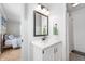 Charming bathroom with a white vanity, new fixtures, a framed mirror, and a shower with curtain at 1109 Oakwood Trl, Indianapolis, IN 46260