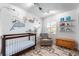 Cozy Bedroom featuring stylish wallpaper, comfortable seating, and plenty of toy storage at 1109 Oakwood Trl, Indianapolis, IN 46260