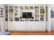 Living room with a built-in shelving unit featuring ample storage and display space at 1109 Oakwood Trl, Indianapolis, IN 46260