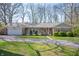 Charming single story home featuring a brick accent, inviting front porch, and manicured lawn at 1109 Oakwood Trl, Indianapolis, IN 46260