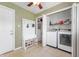 Mud room and laundry area with storage, hall tree, and washer/dryer at 1109 Oakwood Trl, Indianapolis, IN 46260