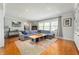 Bright living room with a large sectional sofa, area rug, and natural light from large windows at 1109 Oakwood Trl, Indianapolis, IN 46260