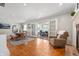 Spacious dining and living area featuring an open floor plan and access to sunroom at 1109 Oakwood Trl, Indianapolis, IN 46260