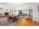 Open-concept living and dining area with wood floors, fireplace, and comfortable seating at 1109 Oakwood Trl, Indianapolis, IN 46260