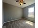 A sun-filled bedroom features a ceiling fan, neutral walls, and soft carpeting at 11152 Dura Dr, Indianapolis, IN 46229