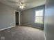 Bright bedroom with neutral walls and carpet, a window, and walk-in closet at 11152 Dura Dr, Indianapolis, IN 46229