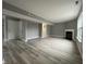 Open-concept living area with fireplace, grey paint, and staircase at 11152 Dura Dr, Indianapolis, IN 46229
