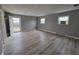Open living room with gray walls, sleek floors, and a door to the outside deck at 11152 Dura Dr, Indianapolis, IN 46229