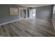 Open living room with sleek floors, gray walls, and lots of natural light at 11152 Dura Dr, Indianapolis, IN 46229
