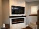 Bright living room featuring a stacked stone fireplace and mounted television at 1140 Hoyt Ave, Indianapolis, IN 46203