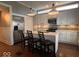 Modern kitchen with stainless steel appliances, quartz countertops, and island seating at 1140 Hoyt Ave, Indianapolis, IN 46203