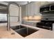 Bright kitchen with stainless steel appliances, quartz countertops, and a chef-style faucet at 1140 Hoyt Ave, Indianapolis, IN 46203