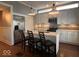 Bright eat-in kitchen with white cabinets, stainless appliances, and seating at the island at 1140 Hoyt Ave, Indianapolis, IN 46203