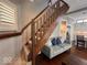 Comfortable living room area with stairs and partial view of the kitchen at 1140 Hoyt Ave, Indianapolis, IN 46203