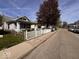 Peaceful street view of home with a white picket fence at 1140 Hoyt Ave, Indianapolis, IN 46203