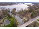 Expansive aerial view showcasing the property's waterfront location with a private dock and tennis court at 11410 Sea Side Dr, Fishers, IN 46040