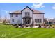 A lush green backyard with a stone patio including an outdoor seating area perfect for entertaining at 11410 Sea Side Dr, Fishers, IN 46040