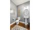 Stylish half bathroom featuring a pedestal sink, decorative mirrors, and modern fixtures at 11410 Sea Side Dr, Fishers, IN 46040