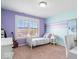 Bright bedroom with playful color scheme, large window, and light carpet provides comfort and style at 11410 Sea Side Dr, Fishers, IN 46040
