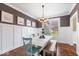 Dining room with modern table and chairs, wainscoting, and hardwood floors at 11410 Sea Side Dr, Fishers, IN 46040