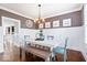 Formal dining room with wainscoting, modern lighting, and hardwood floors at 11410 Sea Side Dr, Fishers, IN 46040