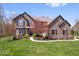 Charming two-story brick home with landscaped front yard and basketball court in driveway at 11410 Sea Side Dr, Fishers, IN 46040
