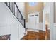 Bright foyer with hardwood floors, staircase, and wainscoting with a high ceiling at 11410 Sea Side Dr, Fishers, IN 46040