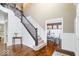 Entryway foyer with staircase, wainscoting, and hardwood floors leading to dining room at 11410 Sea Side Dr, Fishers, IN 46040