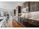Modern kitchen featuring dark wood cabinets, stainless steel appliances, and granite countertops at 11410 Sea Side Dr, Fishers, IN 46040