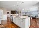 Kitchen with large center island and adjacent living area with fireplace provides an ideal flow for entertaining at 11410 Sea Side Dr, Fishers, IN 46040