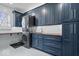Modern laundry room features a sink, counter space, and stacked washer/dryer for convenience and style at 11410 Sea Side Dr, Fishers, IN 46040