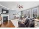Inviting living room with a cozy fireplace, wood floors, and a large sectional couch for relaxing or entertaining at 11410 Sea Side Dr, Fishers, IN 46040