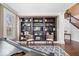 Living room featuring a baby grand piano, two sitting chairs, and large bookshelves at 11410 Sea Side Dr, Fishers, IN 46040