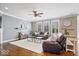 Cozy living room with a fireplace, wood-look floors, and custom wall accents at 11410 Sea Side Dr, Fishers, IN 46040