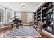 Living room featuring a baby grand piano, two sitting chairs, and large windows at 11410 Sea Side Dr, Fishers, IN 46040