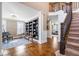 Open concept living room with hardwood floors, piano, and large built-in bookshelves at 11410 Sea Side Dr, Fishers, IN 46040