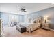 Spacious primary bedroom with a ceiling fan, sitting area, and natural light at 11410 Sea Side Dr, Fishers, IN 46040