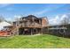 Backyard view showcasing the deck, grassy area, and wooden privacy fence at 1206 Rosengarten Dr, Greenwood, IN 46142