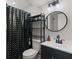 Modern bathroom features updated vanity, lighting, and black shower curtain at 1206 Rosengarten Dr, Greenwood, IN 46142