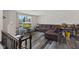 Open-concept living room boasting lots of natural light, wood-look floors and a comfortable brown sofa at 1206 Rosengarten Dr, Greenwood, IN 46142