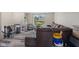 The living room has wood-look floors, plenty of light and a comfortable brown sofa at 1206 Rosengarten Dr, Greenwood, IN 46142