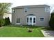 Home's back exterior features a bay window, sliding glass door, and spacious yard at 12326 River Valley Dr, Fishers, IN 46037