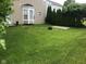 A beautiful backyard featuring lush green grass and a patio area perfect for outdoor entertaining at 12326 River Valley Dr, Fishers, IN 46037