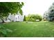 Expansive backyard with lush lawn, mature trees, and a fire pit, perfect for outdoor enjoyment at 12326 River Valley Dr, Fishers, IN 46037