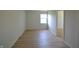 Neutral bedroom with light wood-look flooring, a window, and a closet at 12326 River Valley Dr, Fishers, IN 46037