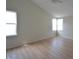 Spacious bedroom with vaulted ceiling, a ceiling fan, two windows, and light wood-look floors at 12326 River Valley Dr, Fishers, IN 46037