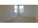 Empty bedroom features natural light from two windows and wood-look flooring at 12326 River Valley Dr, Fishers, IN 46037